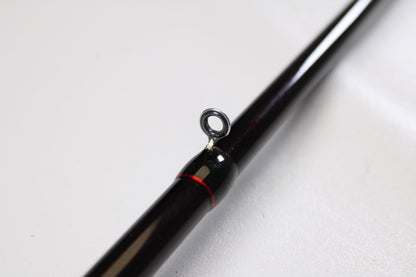 Close-up of the Halo Twilite HFTS711XHC 7'11" Extra Heavy Used Casting Rod in excellent condition, featuring a black finish, metal guide ring, and red accent—ideal for upgrades through our rod and reel trade-in program.