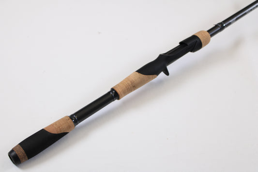 A close-up of the Fenwick World Class Bass WLDB75H-XFC 7'5" Heavy Casting Rod—Used, Excellent Condition—on a white background, ideal for our trade-in program where your used gear earns valuable store credit.