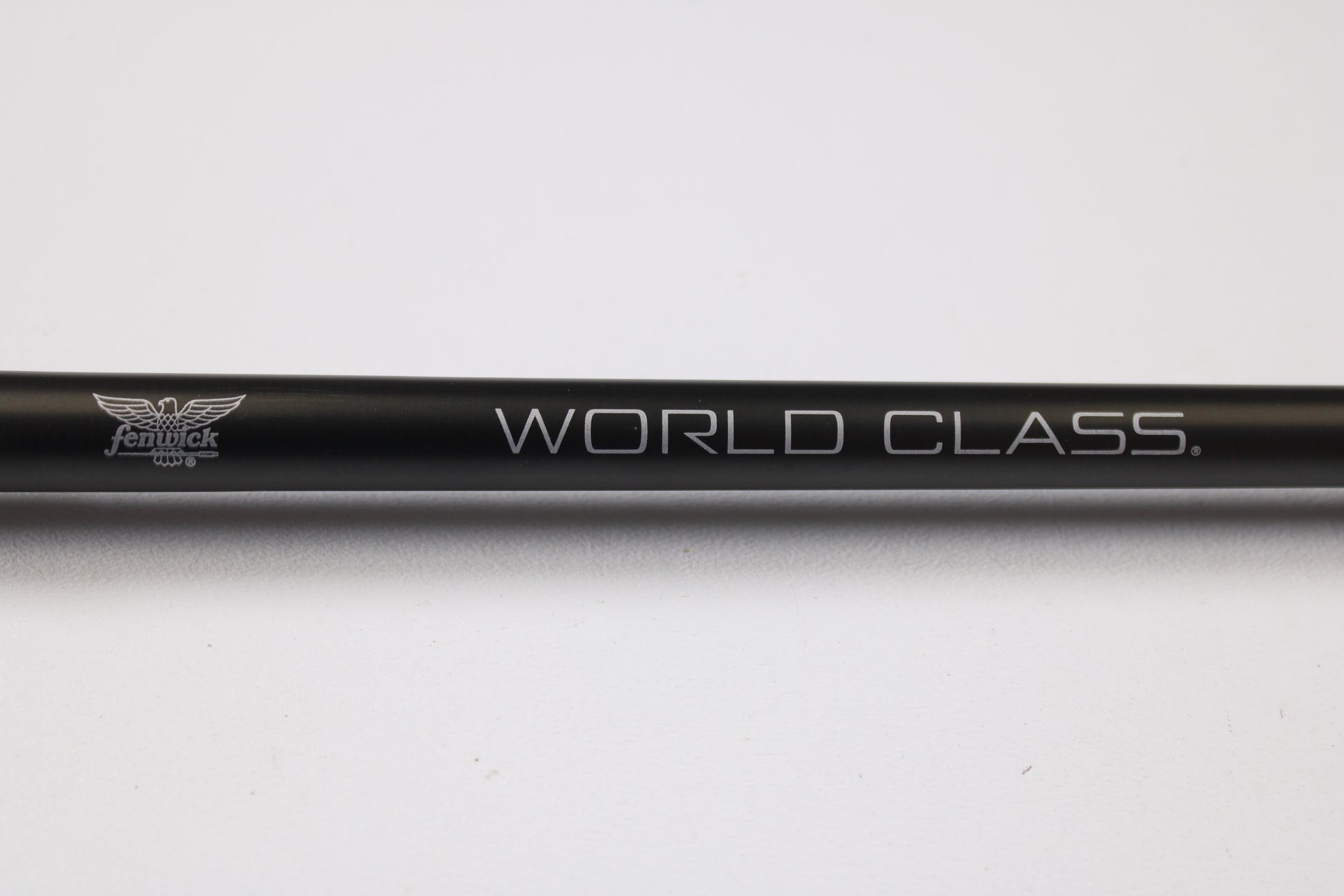 A close-up of the Fenwick World Class Bass WLDB75H-XFC 7'5" Heavy Used Casting Rod in excellent condition, showing the "WORLD CLASS." and small Fenwick logo—ideal for those trading in rods or seeking store credit on used gear.