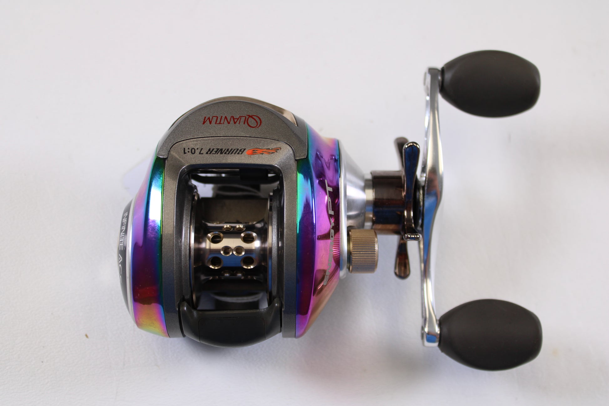 A close-up of the Quantum Energy PT E770PT 7.0:1 RH used casting reel in very good condition, featuring black handles and metallic accents—a great choice for the Rod and Reel Trade-In Program or enhancing your Quantum collection.