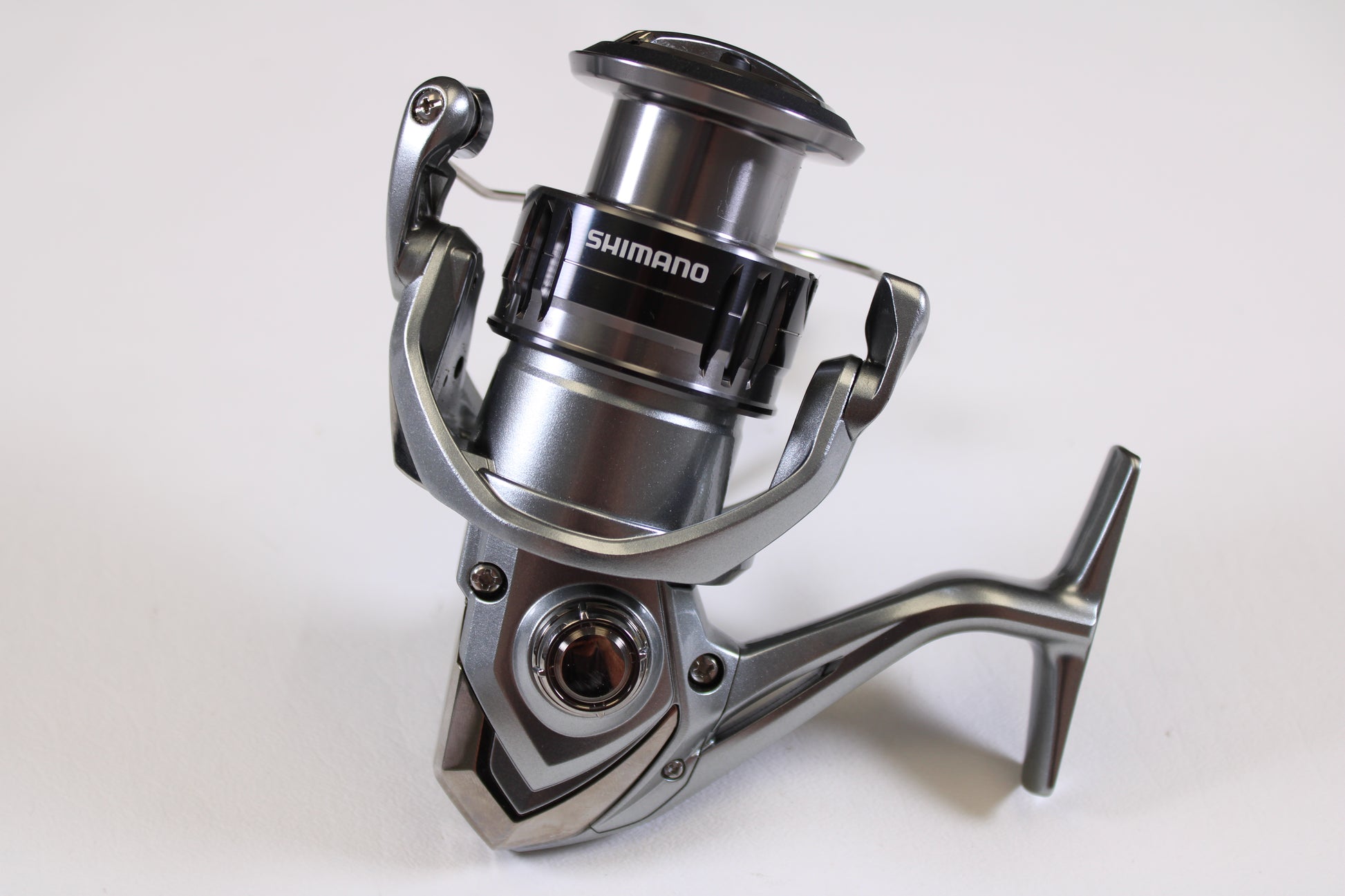 Close-up of a Shimano Nasci FC NAS4000XGFC 6.2:1 Used Spinning Reel in excellent condition on a white background—ideal for our Rod and Reel Trade-In Program if you’re ready to upgrade your Shimano gear.