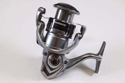 Close-up of a Shimano Nasci FC NAS4000XGFC 6.2:1 Used Spinning Reel in excellent condition on a white background—ideal for our Rod and Reel Trade-In Program if you’re ready to upgrade your Shimano gear.
