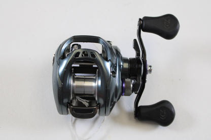 A used Daiwa Tatula SV TW TTUSV103XS 8.1:1 RH casting reel in good condition, with a metallic silver-blue finish and two black handles, ideal for our rod and reel trade-in program. Brand: Daiwa.