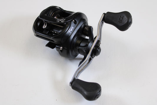 A close-up of the Daiwa Tatula 150 TAT150HSL 7.3:1 LH Used Casting Reel in good condition, featuring two ergonomic handles—ideal for upgrading through our Rod and Reel Trade-In Program or earning store credit on used Daiwa gear.