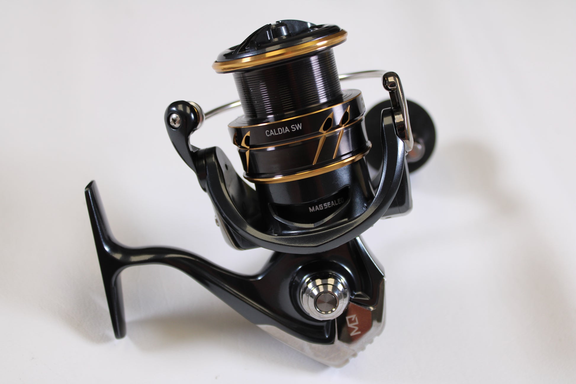 A close-up of the Daiwa Caldia SW 4000-CXH 6.2:1 Used Spinning Reel in excellent condition—perfect for upgrading your gear with our rod and reel trade-in for store credit.
