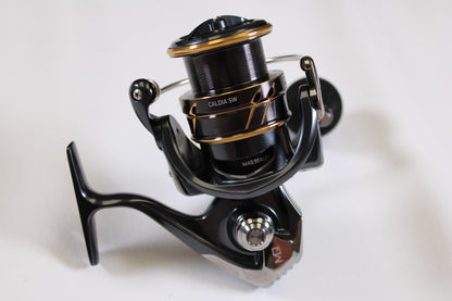 A close-up of the Daiwa Caldia SW 4000-CXH 6.2:1 Used Spinning Reel in excellent condition—perfect for upgrading your gear with our rod and reel trade-in for store credit.