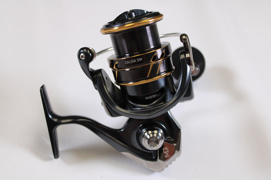 A close-up of the Daiwa Caldia SW 4000-CXH 6.2:1 Used Spinning Reel in excellent condition—perfect for upgrading your gear with our rod and reel trade-in for store credit.