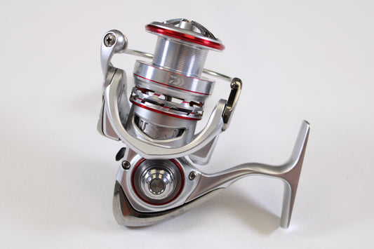 A close-up of the Daiwa Procyon AL PCNALT2500D 5.3:1 Used Spinning Reel in Very Good Condition, photographed on a plain white background—ideal for upgrading via our Rod and Reel Trade-In Program for store credit.