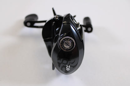 A close-up of the Daiwa Tatula SV TW 70 TTUSVTW70H 7.1:1 RH Used Casting Reel in excellent condition, featuring a black finish, silver adjustment knob, and ergonomic handles—ideal for quality rod and reel trade-ins or store credit.