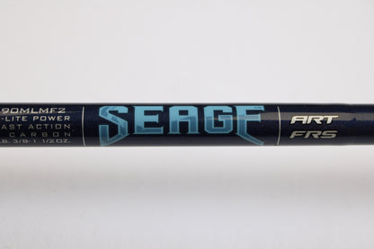 A close-up of the St. Croix Seage SES90MLMF2 9'0" Medium Light 2 Piece Used Spinning Rod in excellent condition, showing bold "SEAGE" lettering and specs—perfect for our Rod and Reel Trade-In Program.