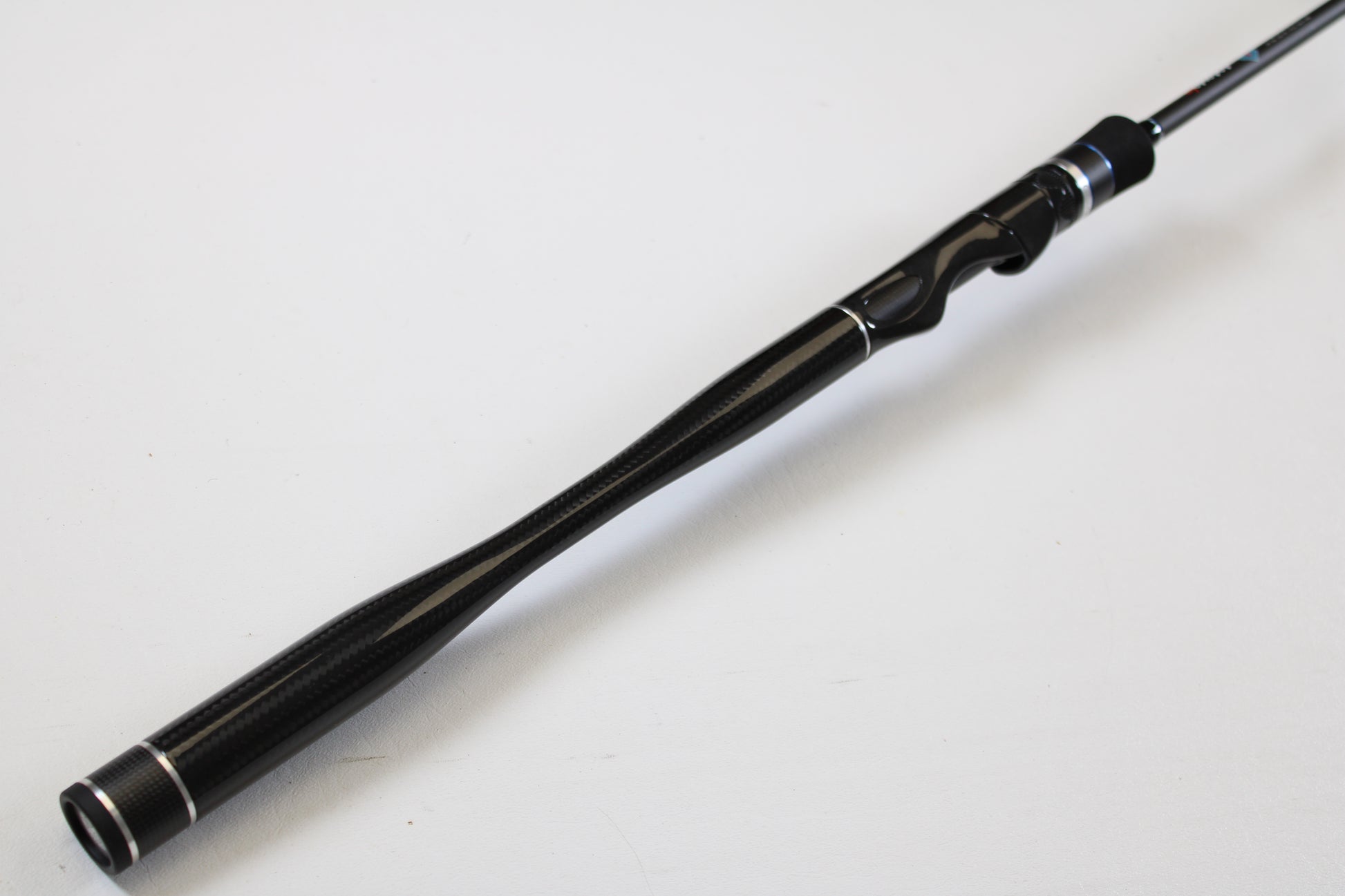 A close-up of the ODM Rods Genesis Inshore BXGX-701LS 7'0" Light used spinning rod in excellent condition, shown against a white background—ideal for anglers seeking quality gear or interested in our trade-in program for store credit.
