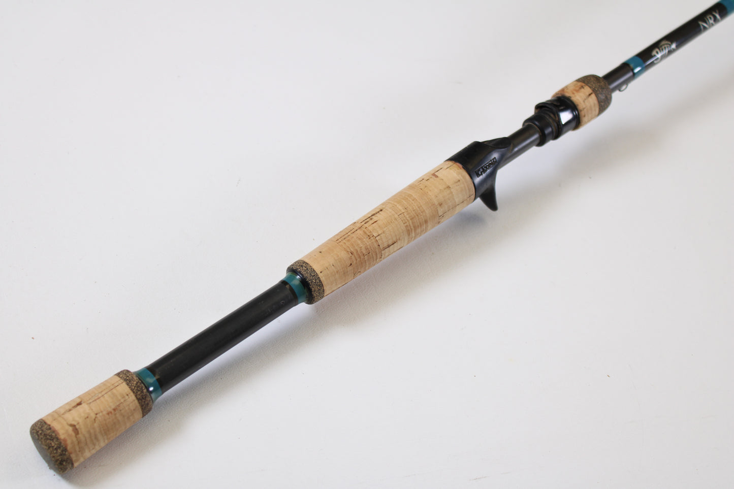 The G. Loomis NRX 893c JWR 7'5" Medium Heavy Used Casting Rod, shown diagonally on white, is perfect for our Rod and Reel Trade-In Program if you want to upgrade your G. Loomis gear for store credit.