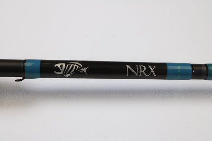 A close-up of the G. Loomis NRX 893c JWR 7'5" Medium Heavy Used Casting Rod in very good condition features the NRX logo and fish skeleton graphic—ideal for anglers trading in gear through our Rod and Reel Trade-In Program.