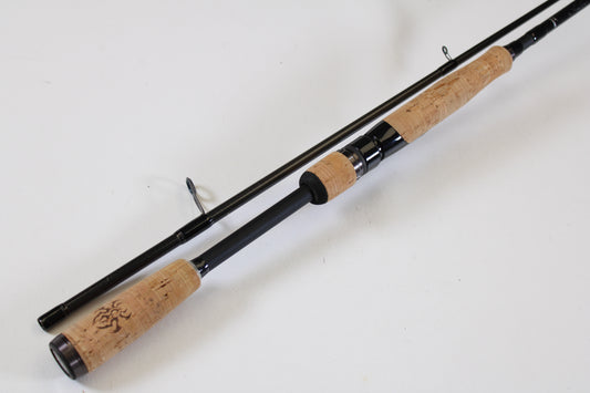 The Daiwa Tatula TTU682MFS 6'8" 2 Piece Used Spinning Rod, in excellent condition, features a black finish with cork handles and metal guides. Great for those seeking value—trade in your old gear with our rod and reel program!.