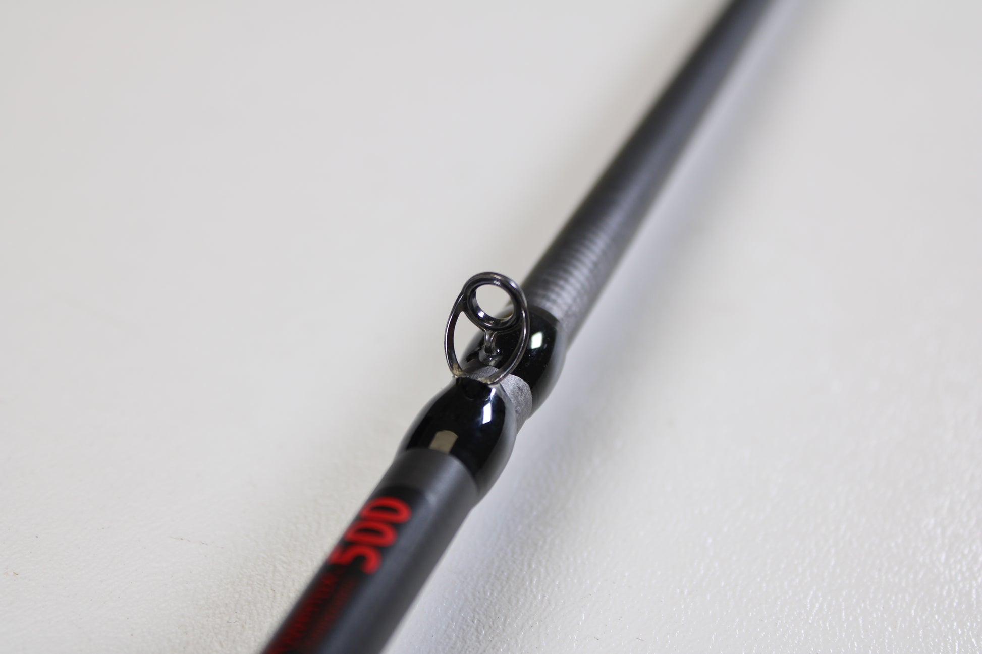 Close-up of an Abu Garcia Fantasista FNXC70-6 7'0" Medium Heavy Used Casting Rod in excellent condition, featuring a sleek black finish with red accents—ideal for those considering our rod and reel trade-in options.