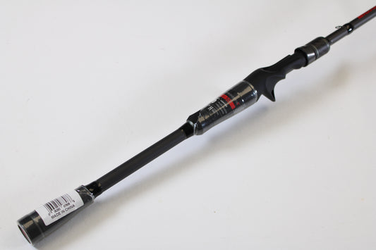 A close-up of an Abu Garcia Fantasista FNXC73-7 7'3" Heavy used casting rod in excellent condition, featuring a trigger grip handle and barcode sticker—ideal for use with store credit or trade-in programs. Set against a plain white background.