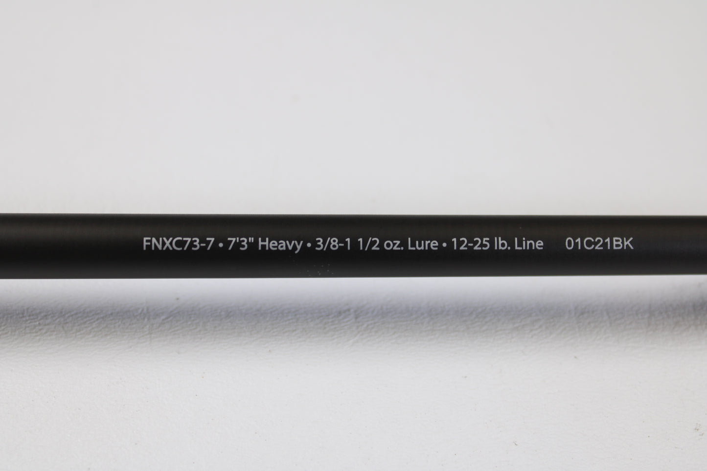 A close-up of the Abu Garcia Fantasista FNXC73-7 7'3" Heavy Used Casting Rod in excellent condition, with specs printed in white—perfect for the Rod and Reel Trade-In Program or earning store credit with your used Abu Garcia gear.