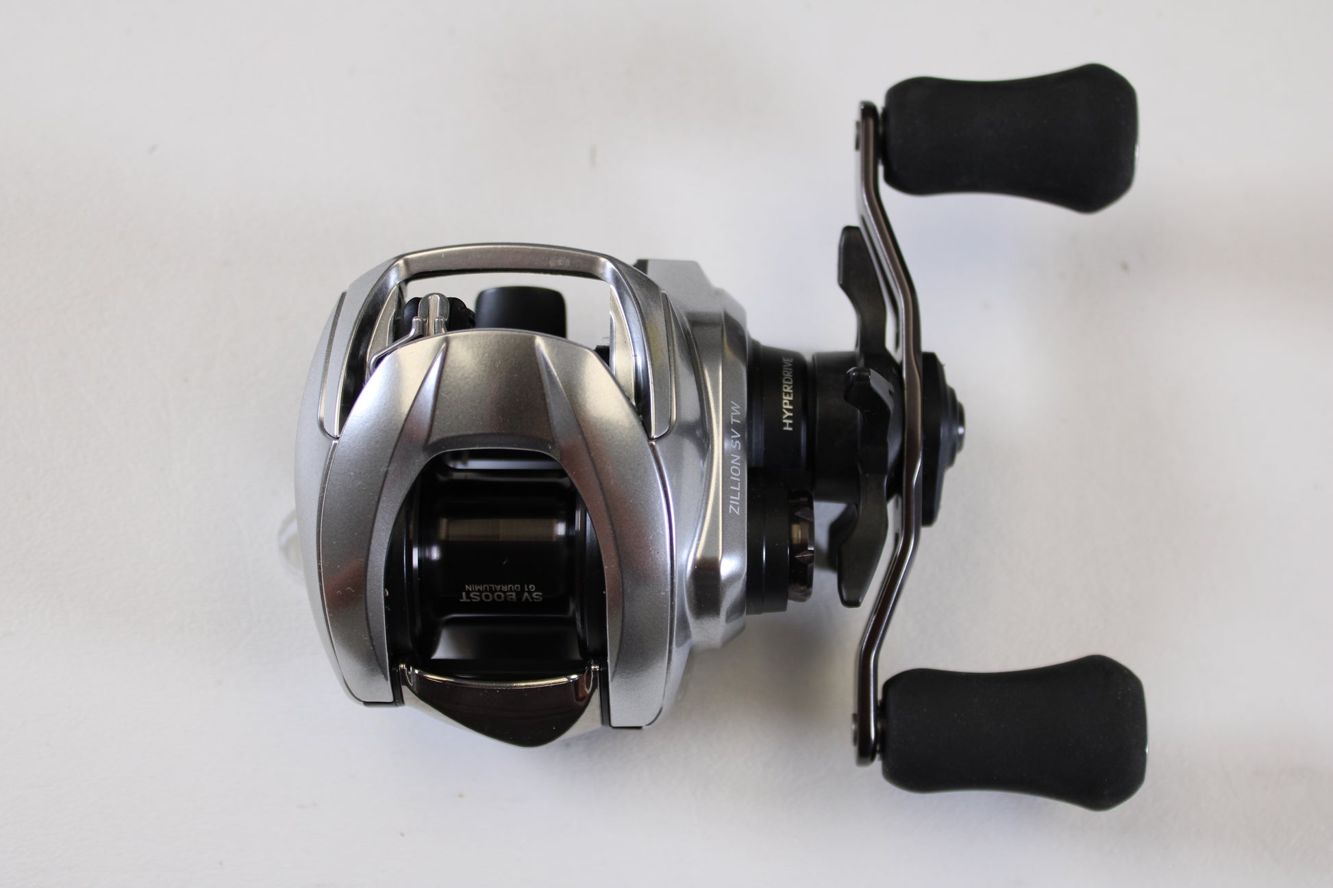 The Daiwa Zillion ZLNSVG100 6.3:1 RH Used Casting Reel—excellent condition with two black handles—perfect for anglers upgrading through our trade-in program or shopping quality used reels.