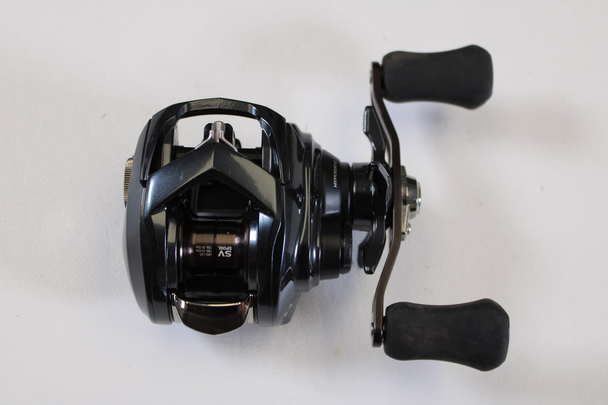 The Daiwa Tatula SV 70 TTUSV70 6.3:1 RH Used Casting Reel (Excellent Condition) is shown, ideal for upgrading via our Rod and Reel Trade-In Program for store credit. Brand: Daiwa.