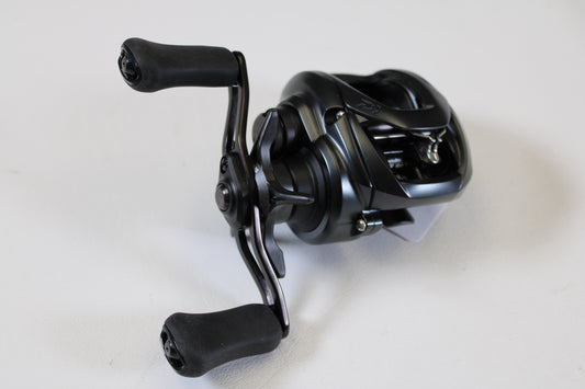 A close-up of a Daiwa Tatula Elite TAEL100XS 8.1:1 RH used casting reel in excellent condition, perfect for customers interested in upgrading gear or participating in our rod and reel trade-in program. Set against a plain white background.