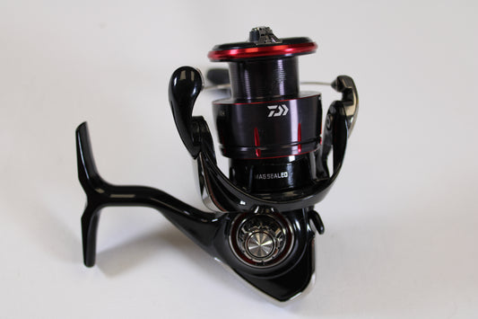 A close-up of a Daiwa Fuego LT FGLT2500D-XH 6.2:1 used spinning reel in excellent condition, standing upright on a white background—perfect for the Rod and Reel Trade-In Program to earn store credit on used Daiwa gear.
