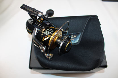 A Shimano Stella SW C STLSW18000HGC used spinning reel in mint condition by Shimano is shown on its case and box against a white background—ideal for those interested in our Rod and Reel Trade-In Program.