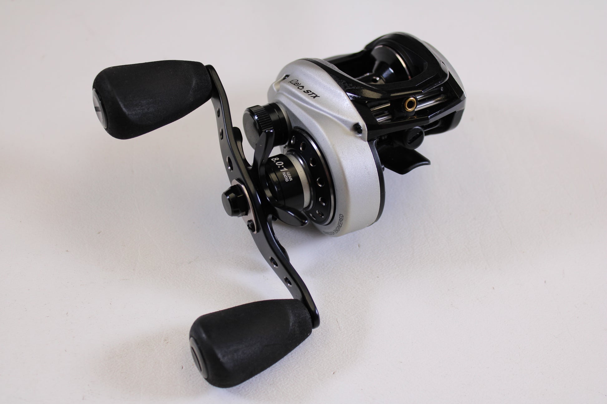 A close-up of the Abu Garcia Revo STX Gen 4 REVO3STX-SHS 8.0:1 RH, a used casting reel in excellent condition—ideal for those looking to upgrade through our Rod and Reel Trade-In Program.