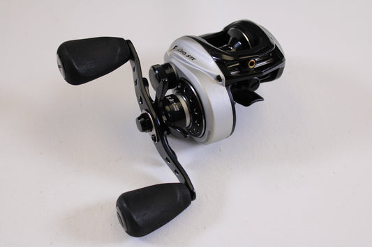 A close-up of the Abu Garcia Revo STX Gen 4 REVO3STX-SHS 8.0:1 RH, a used casting reel in excellent condition—ideal for those looking to upgrade through our Rod and Reel Trade-In Program.