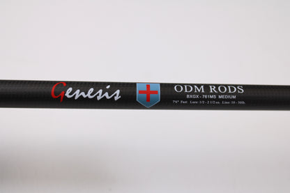 Close-up of an ODM Rods Genesis Inshore BXGX 761MS 7'6" Medium used spinning rod with blue and red shield logo. Specs: Fast action, 1/2–2 1/2 oz., line rating 10–30 lb. Ideal for anglers using our rod and reel trade-in program.