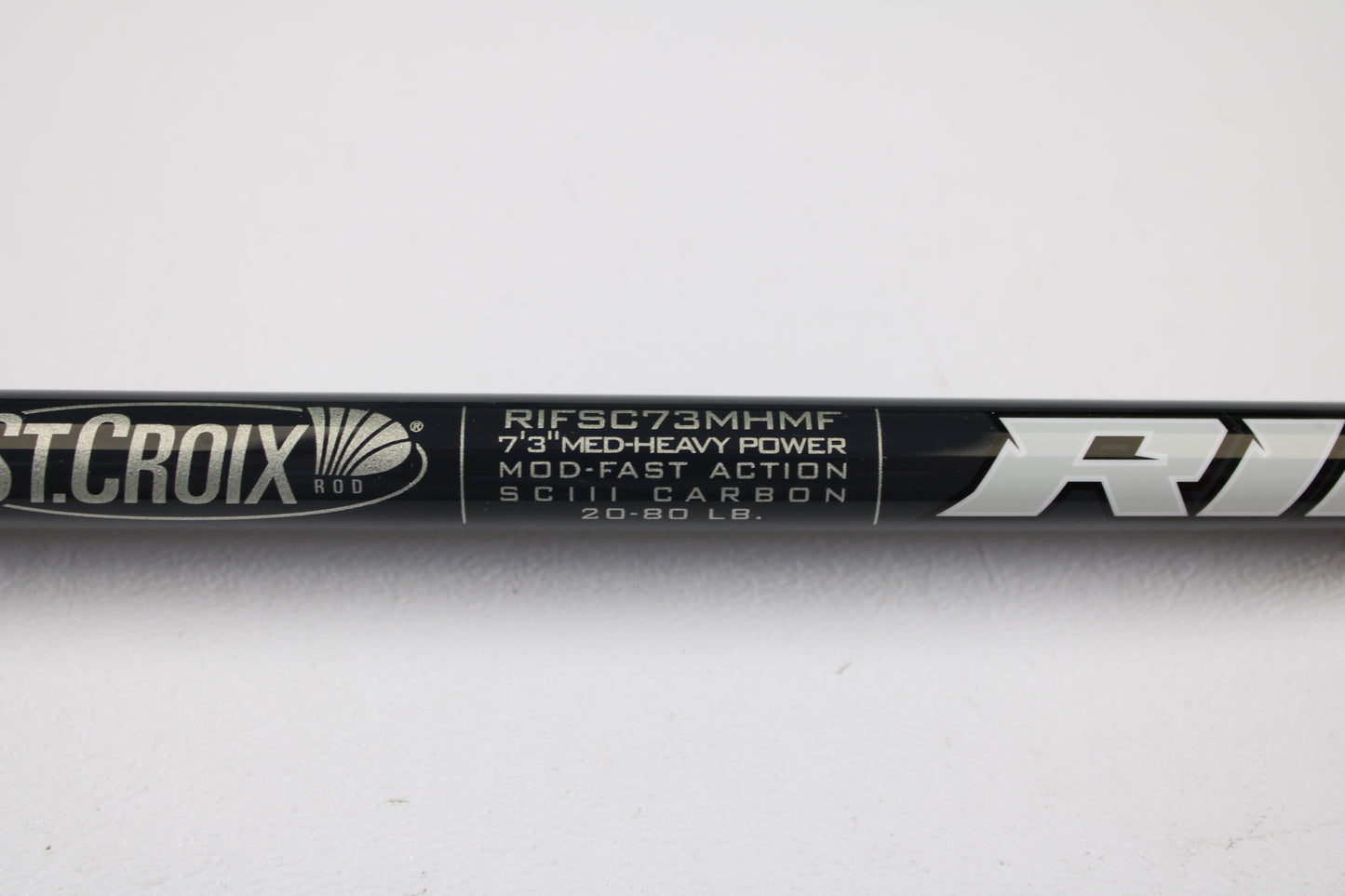 Close-up of a St. Croix Rift RIFSC73MHMF 7'3" Medium Heavy Used Conventional Rod in mint condition. Trade in your used gear for store credit with our rod and reel trade-in program. White text on black background.
