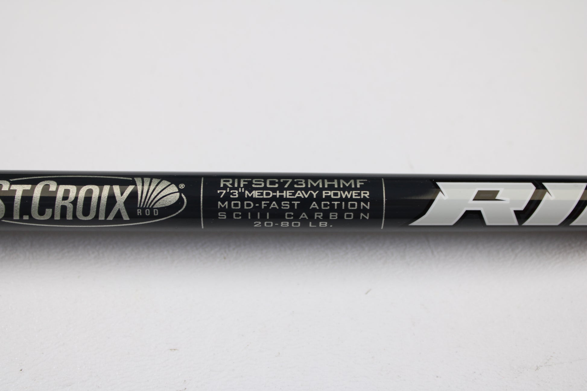 Close-up of a St. Croix Rift RIFSC73MHMF 7'3" Medium Heavy Used Conventional Rod in mint condition. Trade in your used gear for store credit with our rod and reel trade-in program. White text on black background.
