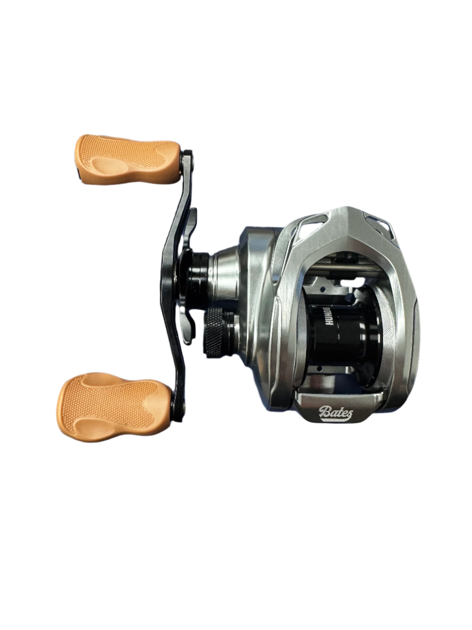 The Bates Hundo 7.1:1 LH Gear Ratio Used Casting Reel by Bates Fishing Co. features two textured tan handles, a black spool, and silver finish—ideal for anglers seeking quality used gear or Rod and Reel Trade-In options.