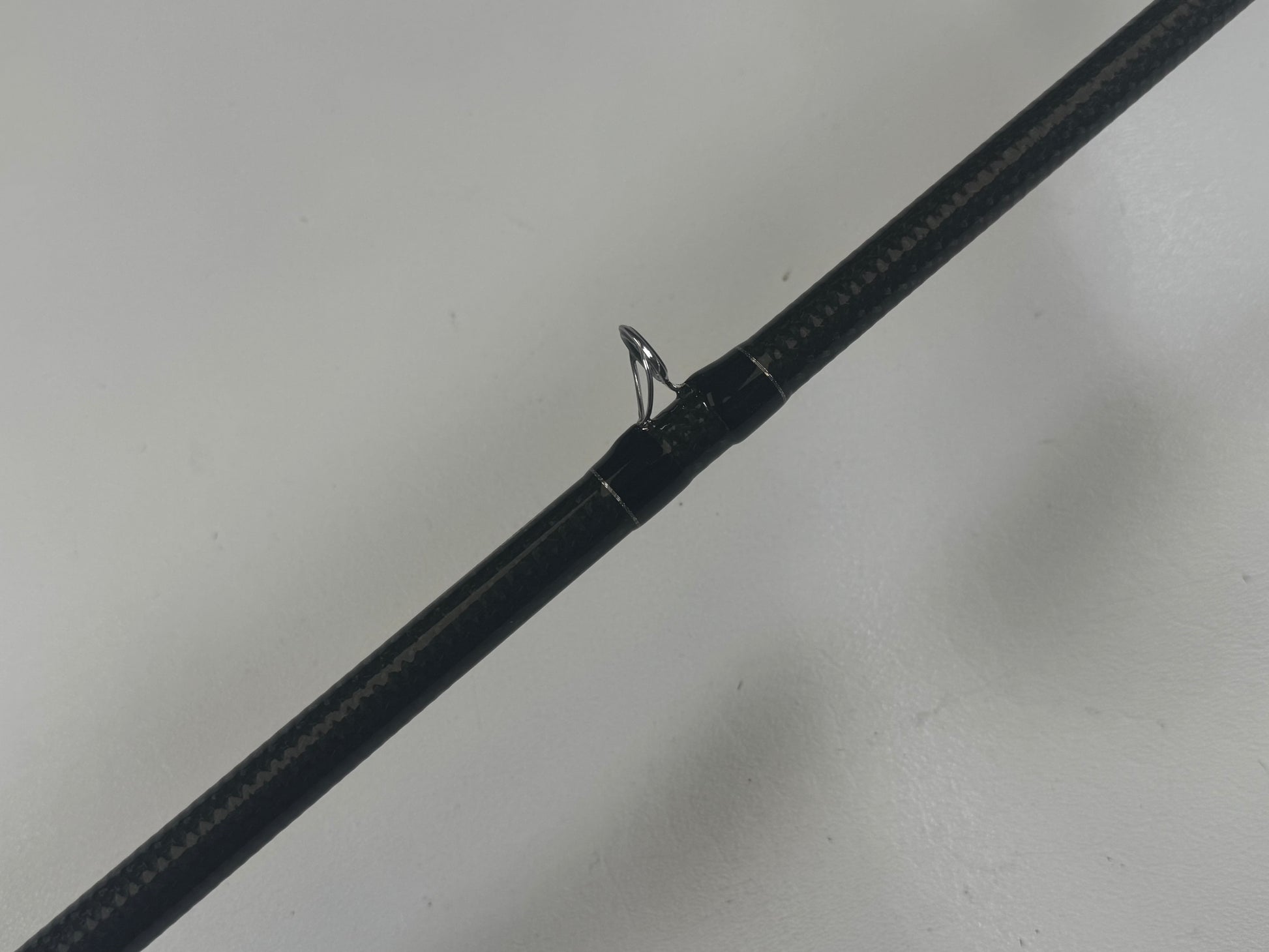Close-up image of a Daiwa BLX BLXSG7111XHXB casting rod in excellent condition, featuring a single metal guide ring against a light gray background.