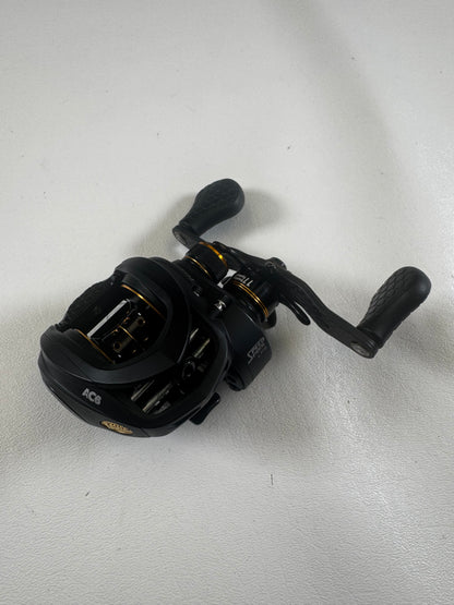 The Lew's Tournament Pro TP1SHLA 7.5:1 used casting reel in excellent condition features gold accents, textured handle grips, and multiple adjustment knobs. Trade in your gear for store credit with our Rod and Reel Trade-In program!.