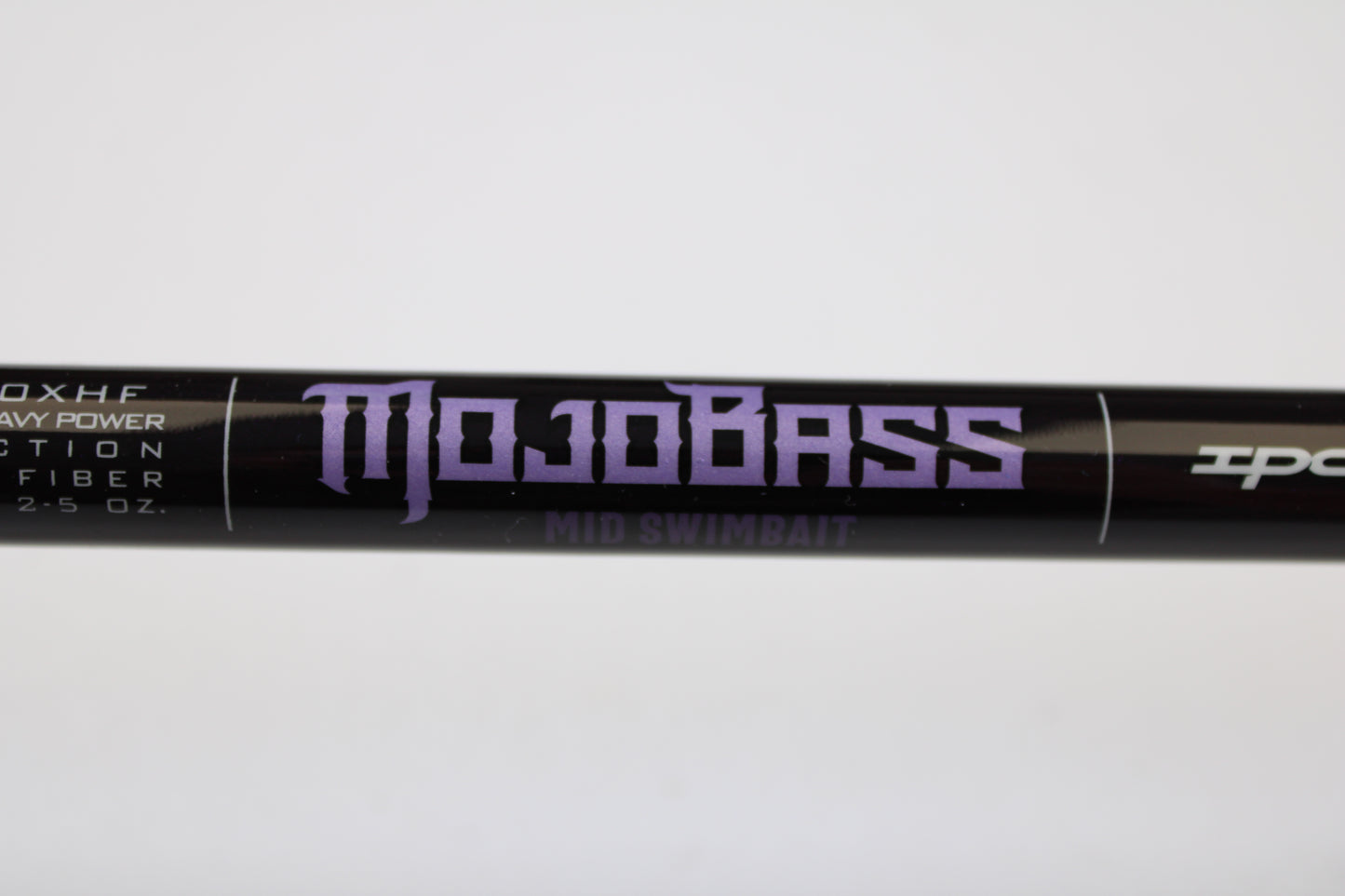 A close-up of a black St. Croix Mojo Bass JOC710XHF Mid Swimbait 7'10" XH used casting rod in mint condition, part of our used gear selection and potentially eligible for our Rod and Reel Trade-In Program. White specs are visible on the rod.