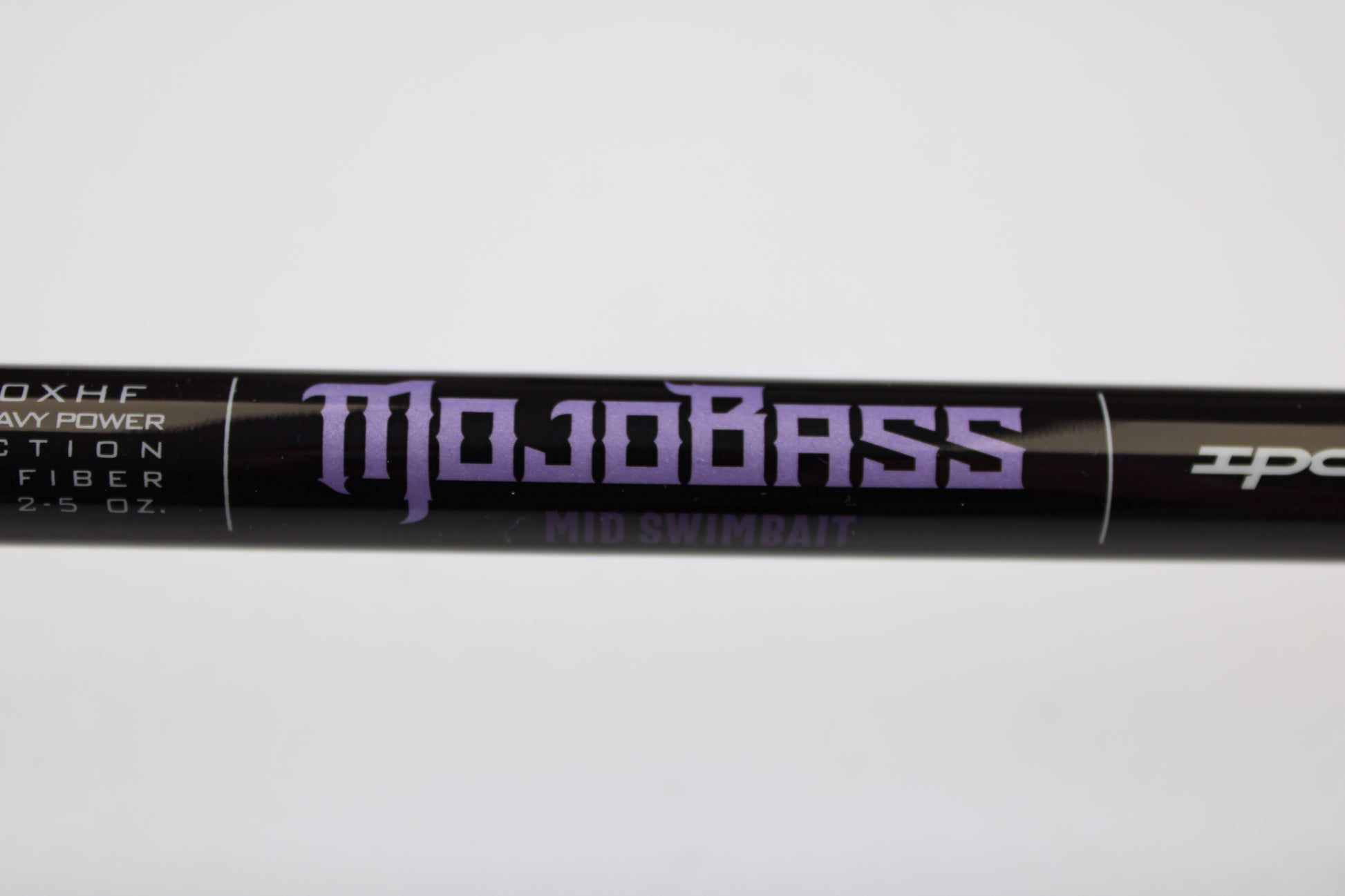 A close-up of a black St. Croix Mojo Bass JOC710XHF Mid Swimbait 7'10" XH used casting rod in mint condition, part of our used gear selection and potentially eligible for our Rod and Reel Trade-In Program. White specs are visible on the rod.