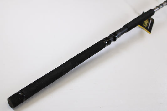 A close-up of the St. Croix Mojo Musky Trolling MMT90XHM2 9'0" XH—used casting rod in mint condition—features a black foam handle on a white surface, ideal for those trading up through our Rod and Reel Trade-In Program.
