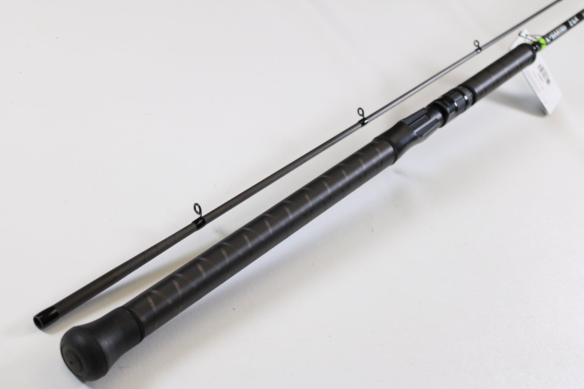 A close-up of the G. Loomis E6X Steelhead 1021-2C HSR GH Used Casting Rod in mint condition, featuring a textured handle and line guides—ideal for those exploring used gear or our rod and reel trade-in program.