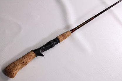 A G. Loomis IM6 CR 664C 5'6" Heavy - Used Casting Rod in good condition, shown diagonally on a white surface—ideal for anglers seeking quality used G. Loomis gear or considering our rod and reel trade-in for store credit.