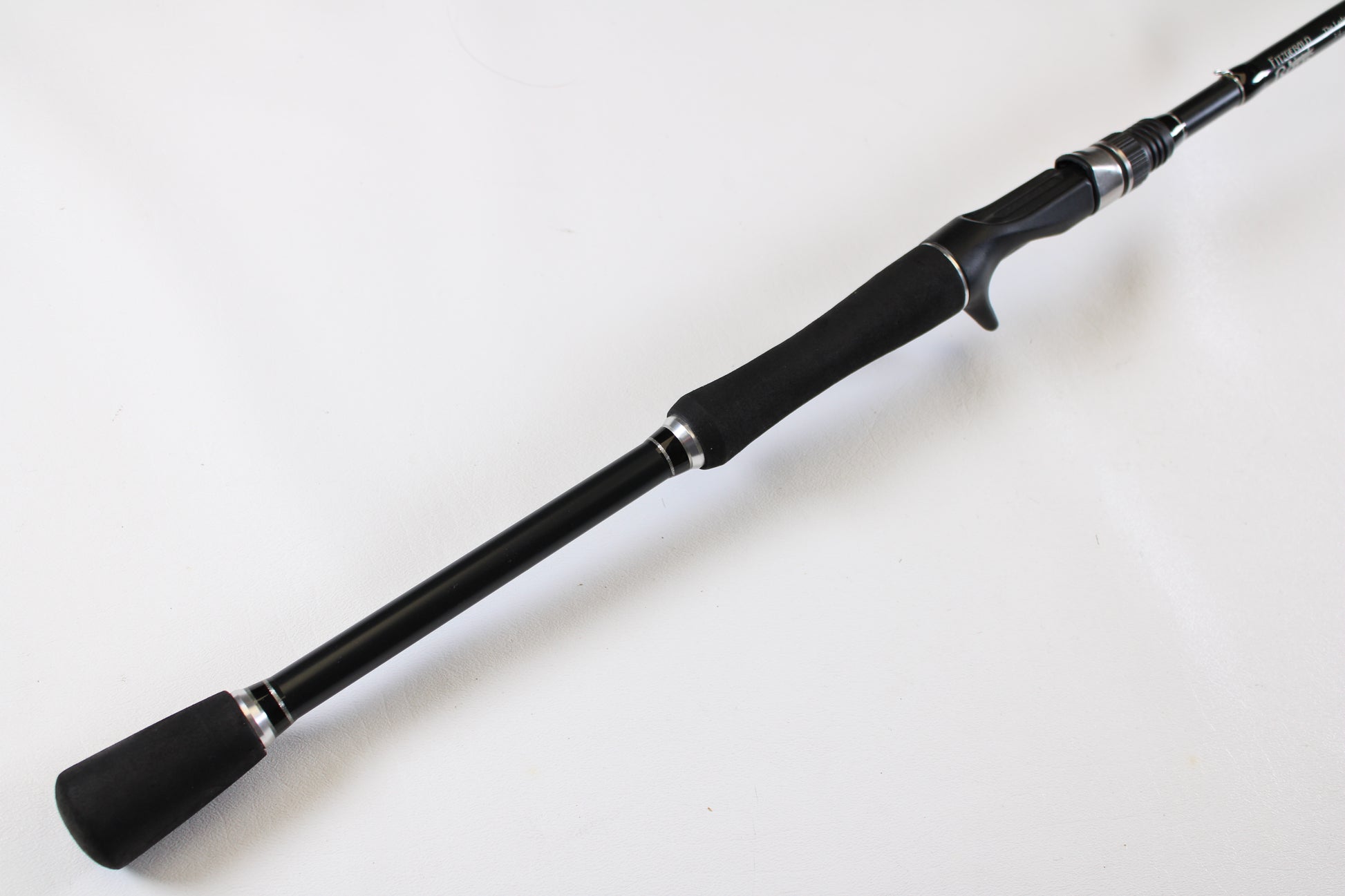 A close-up of the Fitzgerald Original TLR710H The Ledge Rod 7'10" Heavy, a used casting rod in very good condition with foam grips and reel seat—ideal for our Rod and Reel Trade-In Program if you want to upgrade for store credit.