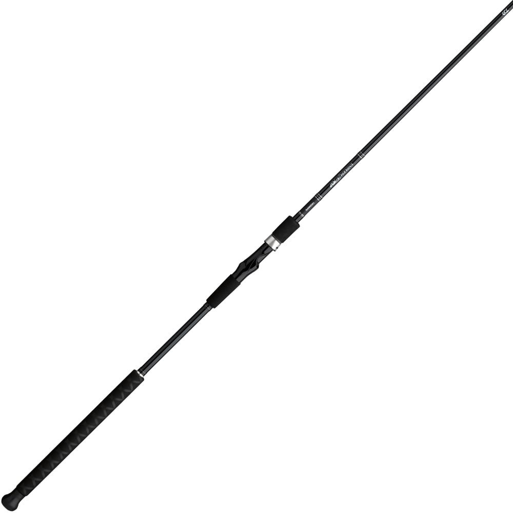 The Daiwa Emblem Pro Surf Rod Spinning 12'0" Medium Heavy 2pc | EMBLM1202MHFS features a sleek black design with a textured grip handle and a thin, extended rod. This medium-heavy rod includes several metal guides for excellent fishing line management.