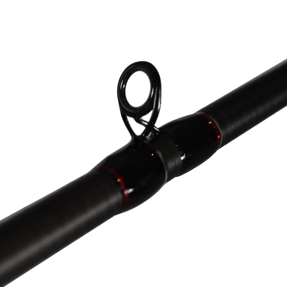 Close-up of the dark-coated Dobyns Kaden Casting Rods 7'4" Heavy | KD 744C, highlighting a line guide with black wrap and glossy finish. The white background emphasizes the high modulus blank's craftsmanship and durability.