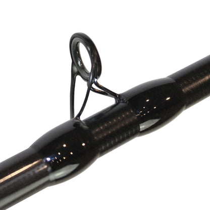 The close-up of the Dobyns Maverick Series MK 735C casting rod reveals a smooth, shiny surface with a focus on the line guide, highlighting the craftsmanship with its metal ring and supportive thread wraps.