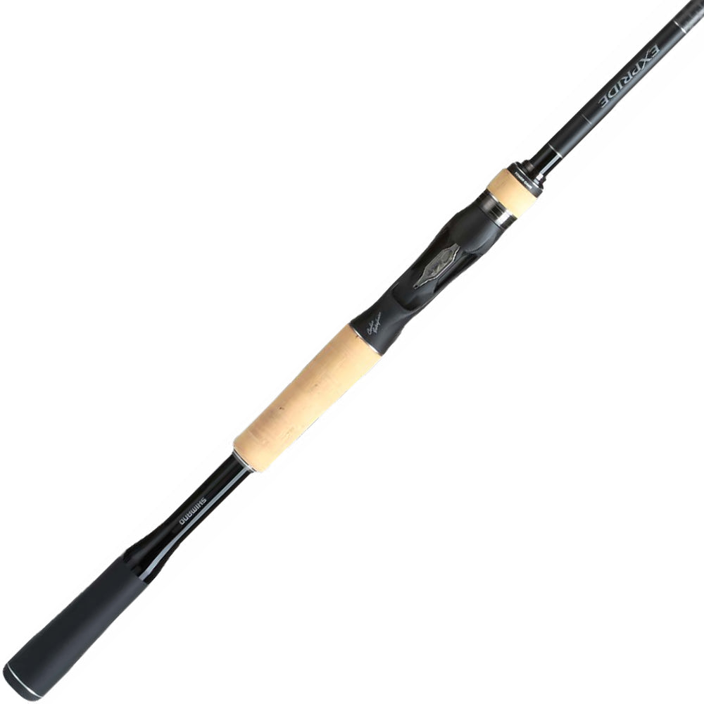 The Shimano Expride B Casting Rod 7'2" Heavy | EXC72HB features a sleek black and beige design with Hi-Power X technology. Its cork-wrapped handle ensures comfort, while its shiny finish and lightweight durability provide a modern look for any angler.