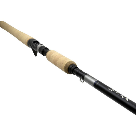 A close-up of the Shimano Skixx Muskie 8'0" Extra Heavy Casting Rod (SKC80XH) by Shimano shows its cork handle and reel seat, with the black Spiral X rod extending out of the frame.