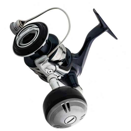 A close-up of the Shimano Twin Power SW Spinning Reel 14000XGC 6.2:1 by Shimano, featuring a sleek black and silver design, photographed from a low angle on a white background—perfect for offshore game fish.