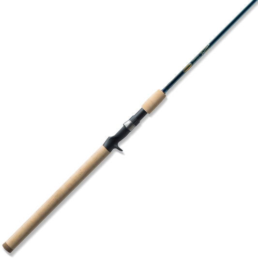 The St. Croix Triumph Casting Rod 7'0” Medium Heavy (TCR70MHF) by St. Croix, with a light cork handle, slender dark blue SCII carbon shaft, and a dark reel seat, is shown on a white background.