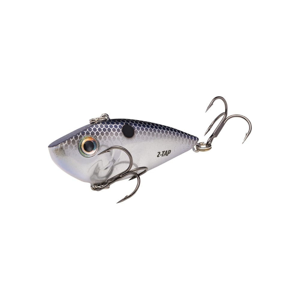 The Strike King Red Eye Shad Tungsten 2 Tap is a lipless crankbait crafted for anglers, featuring a fish-like design with a metallic blue and silver body, black spots, two treble hooks, and a realistic eye for optimal performance.
