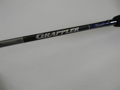 A close-up of the Shimano Grappler Type C GRPCS70L 7'0" Light Used Spinning Rod in excellent condition, featuring "GRAPPLER" in bold silver letters—ideal for those looking to upgrade with our Rod and Reel Trade-In Program.