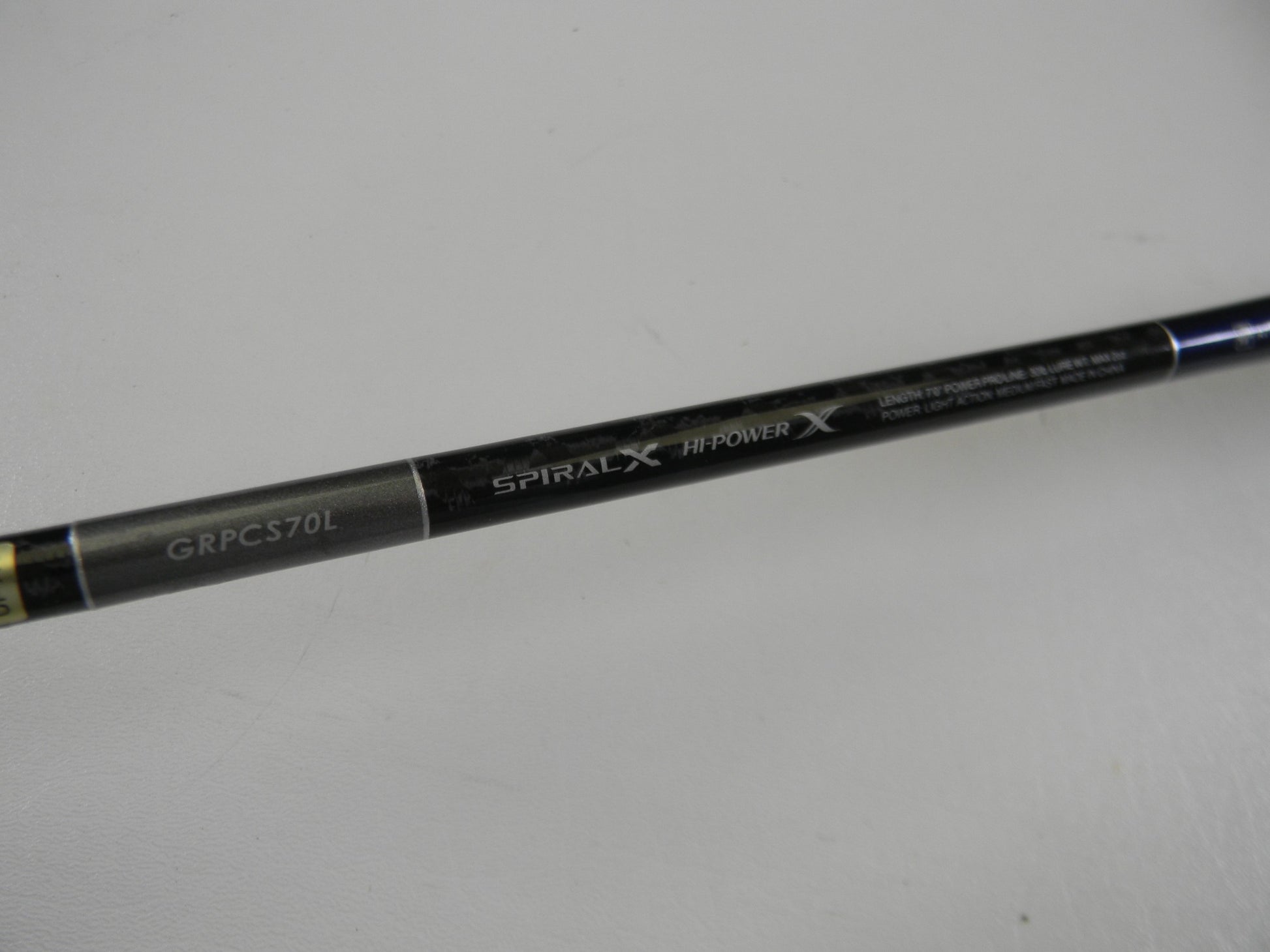 A close-up of a Shimano Grappler Type C GRPCS70L 7'0" Light Used Spinning Rod in excellent condition, showing "GRPCS70L," "SPIRAL X," and "HI-POWER X"—ideal for upgrading with our Rod and Reel Trade-In Program.